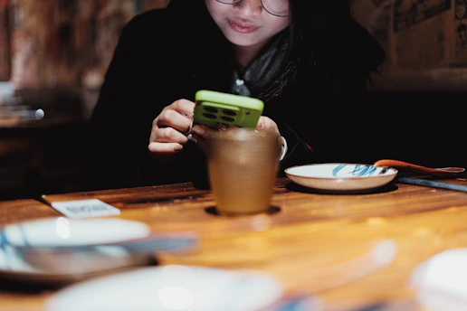A person looks at their phone at a restaurant.
