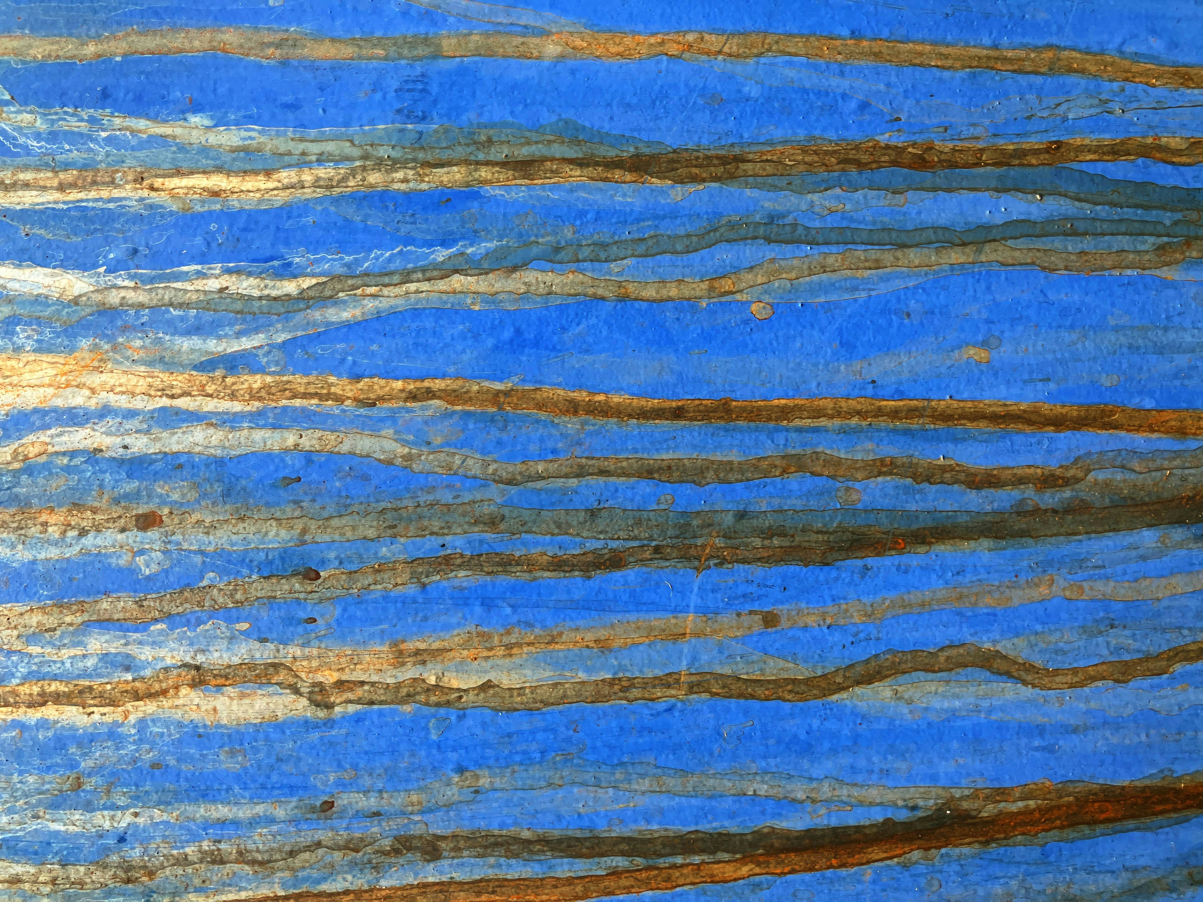 Blue abstract art with horizontal brown lines.