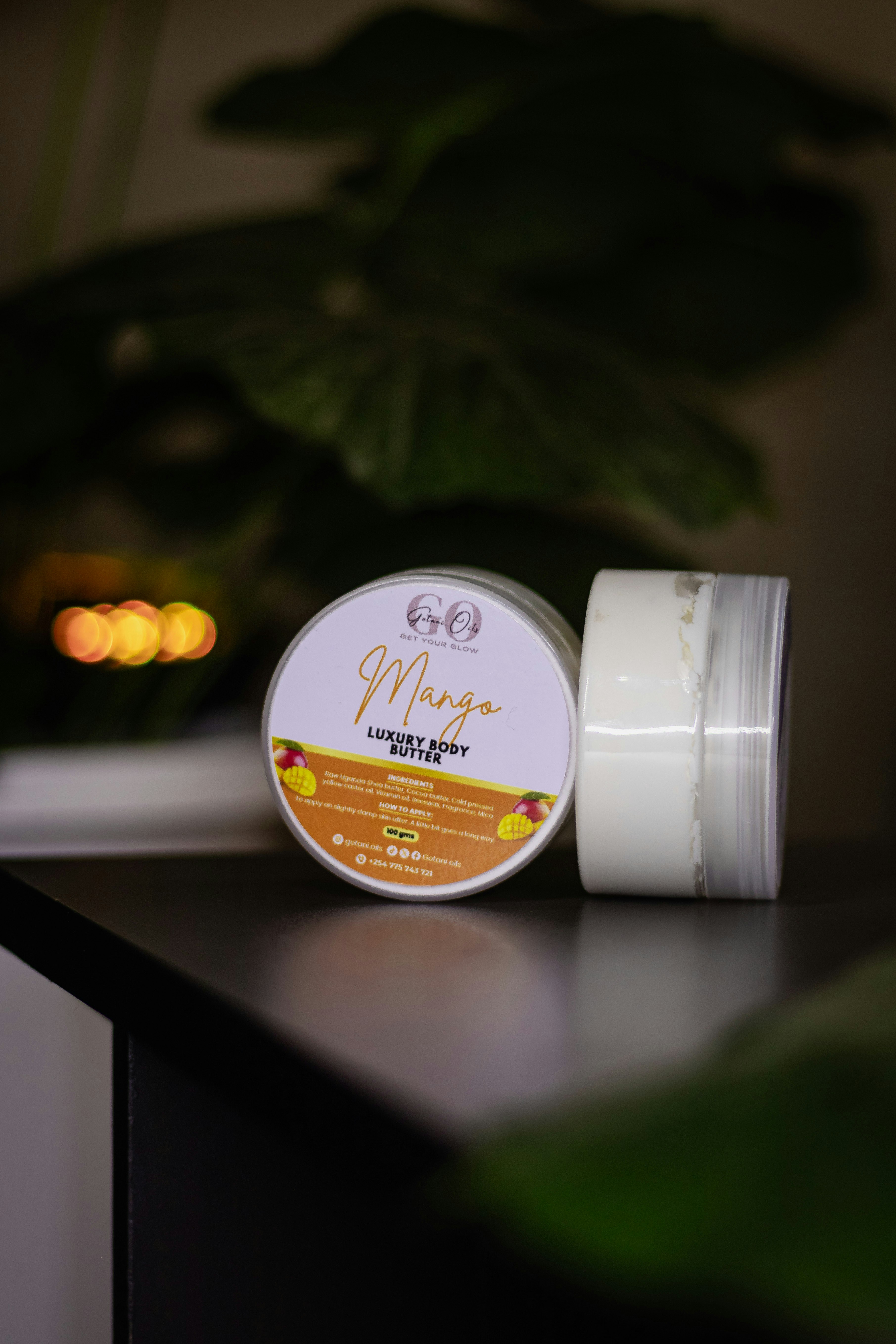 Mango luxury body butter containers are displayed.