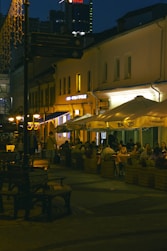 Nightlife unfolds at an outdoor cafe.