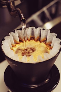 Pouring hot water over coffee grounds.