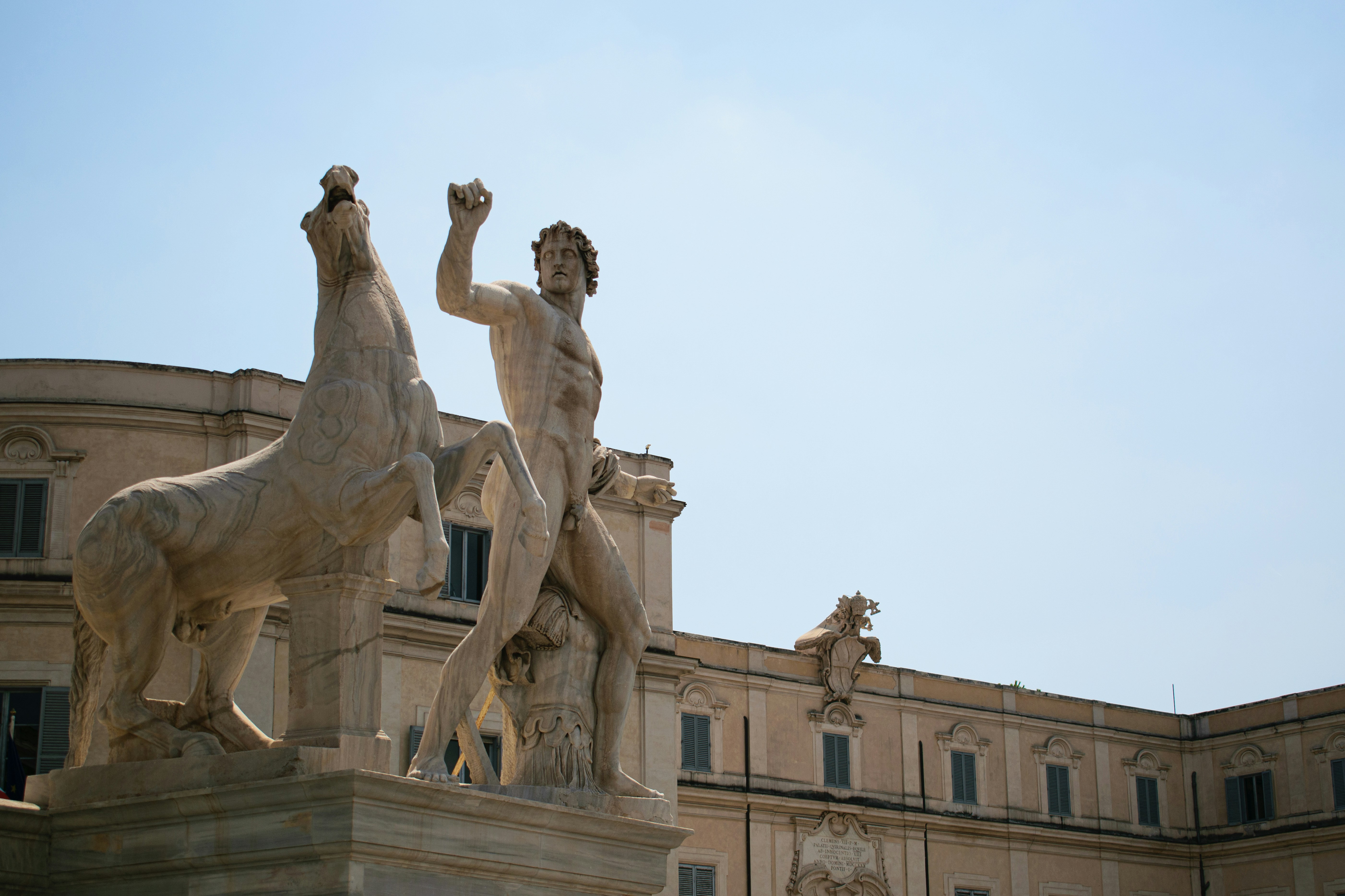 A statue of a man and horse stands tall.