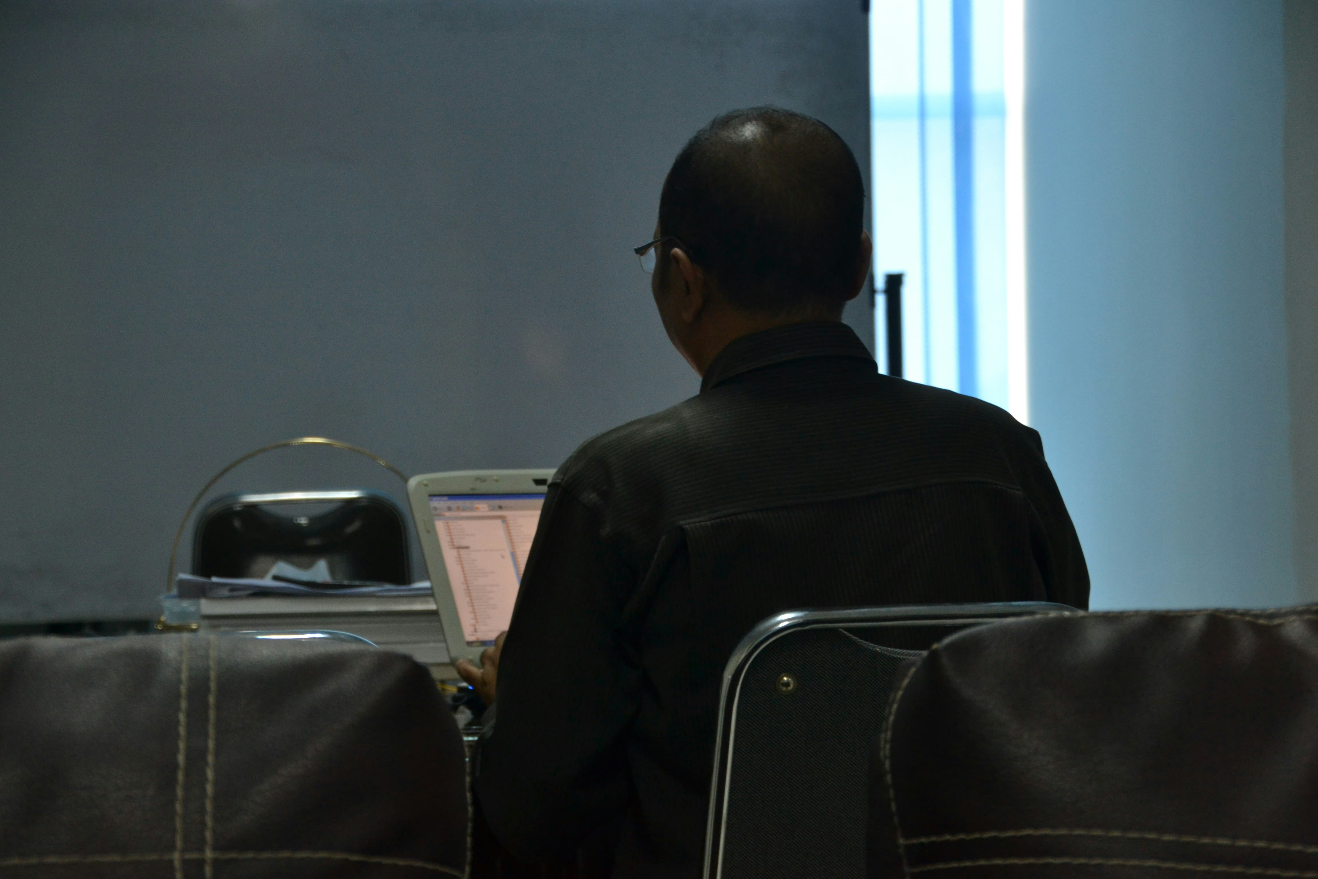 An airline representative in a formal setting explaining operational costs to a panel.