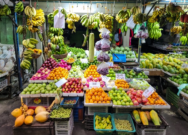 A fruit stand is loaded with colorful produce.
