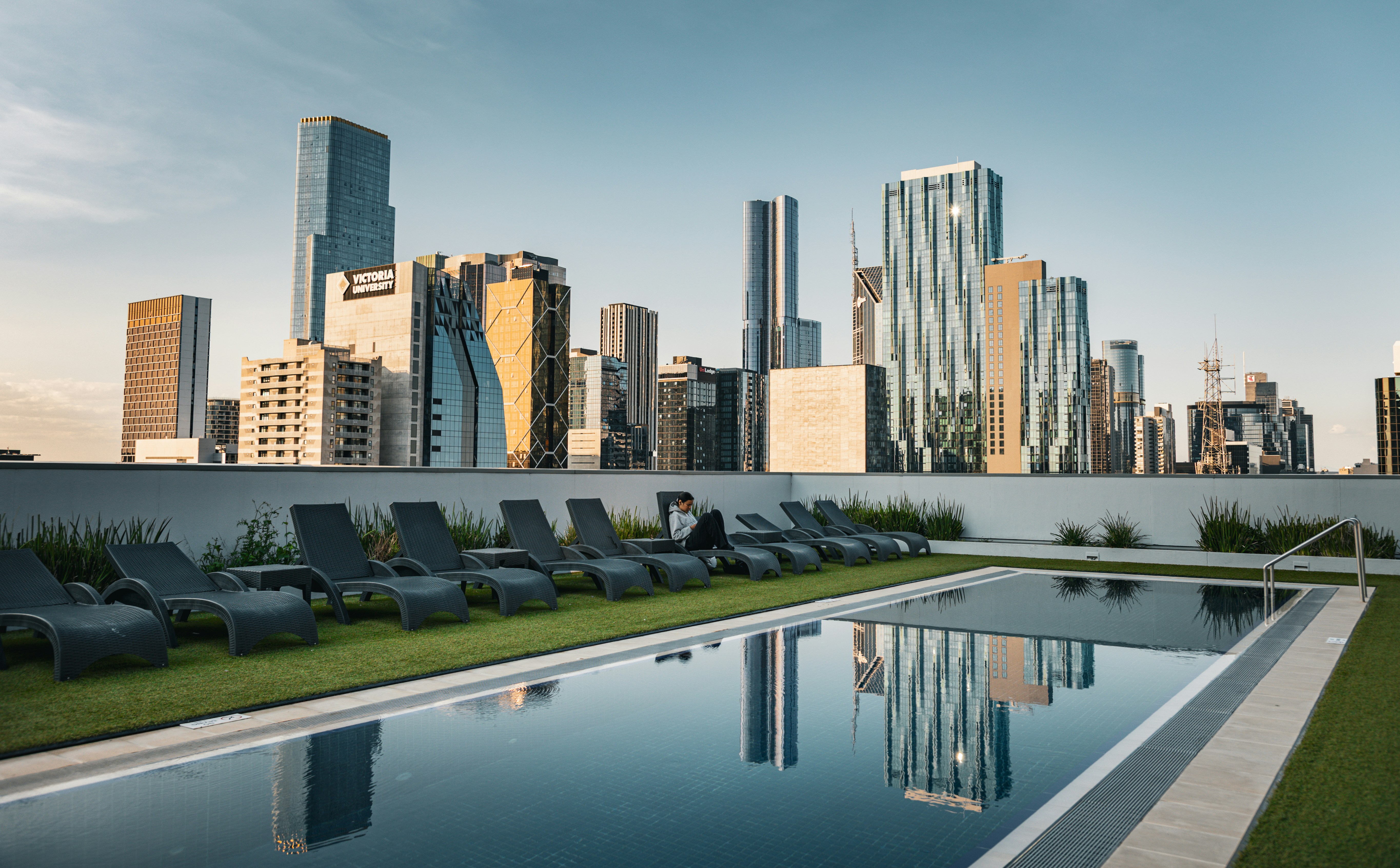 stunning rooftop pool and lounge area with a view of the Chicago skyline - luxury apartments gold coast chicago