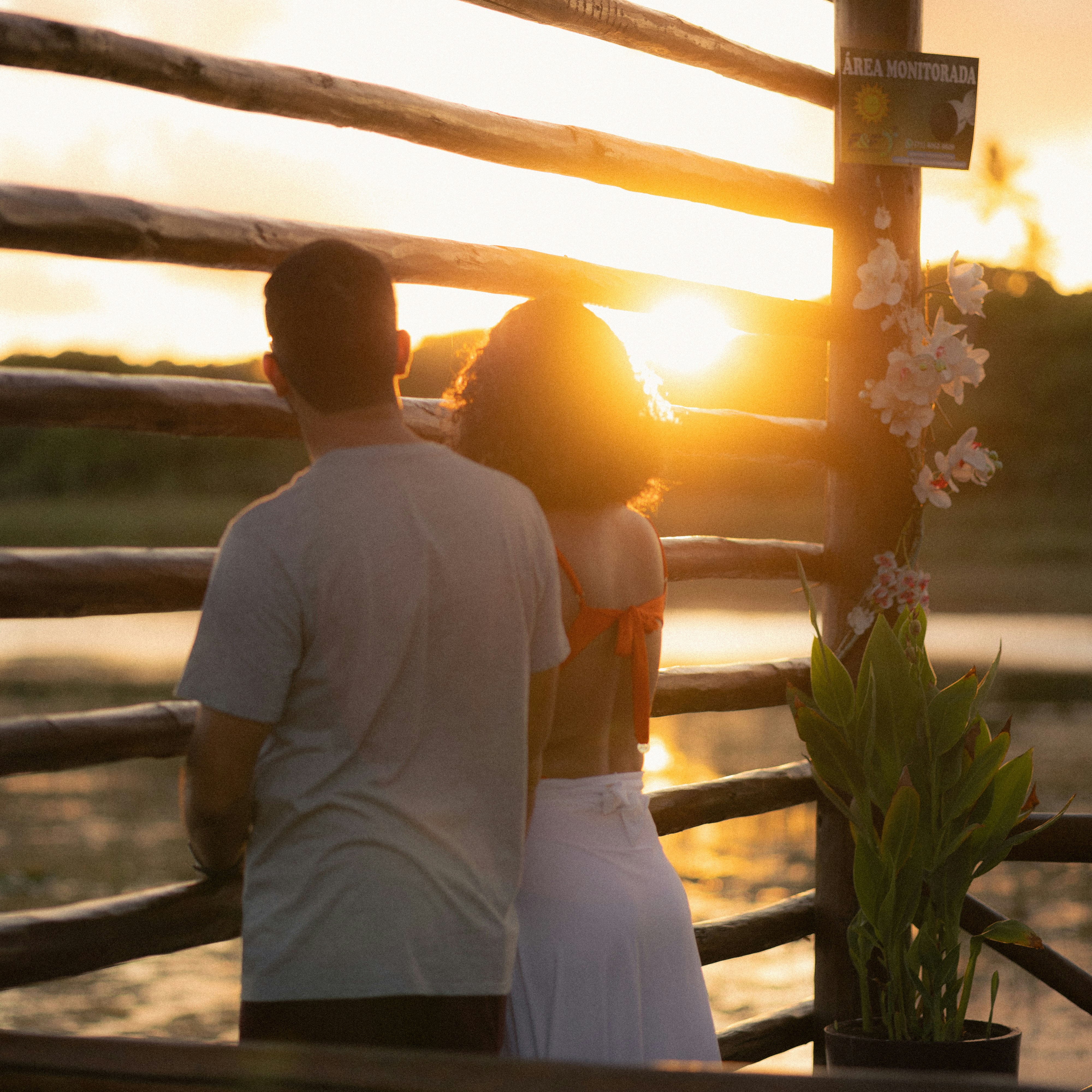 Ranch wedding couple standing together during a dramatic sunset