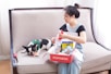 Woman opens a dog box with her dog.
