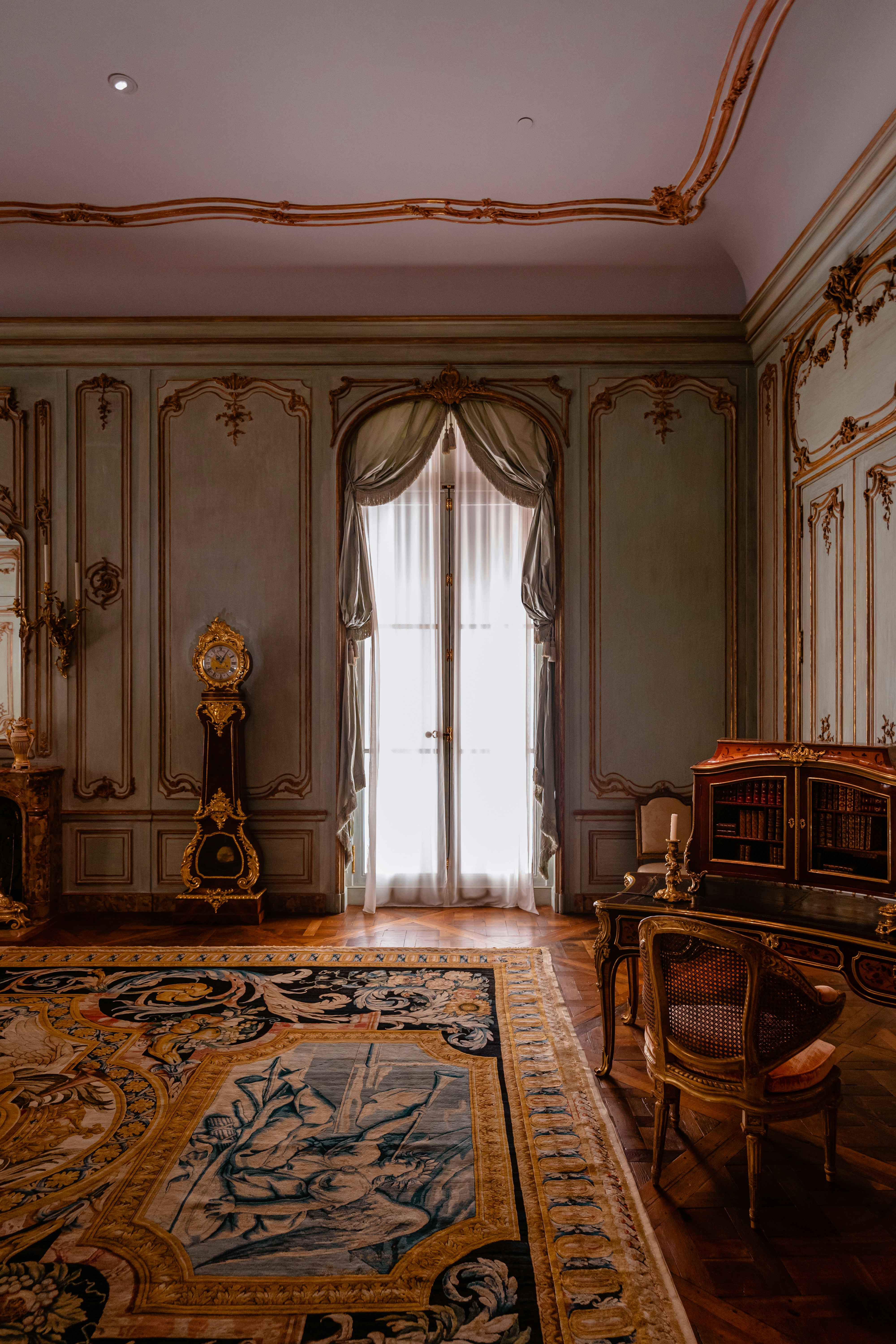 A luxurious room with antique furniture and decorations.