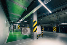 Modern parking garage interior with ventilation systems.