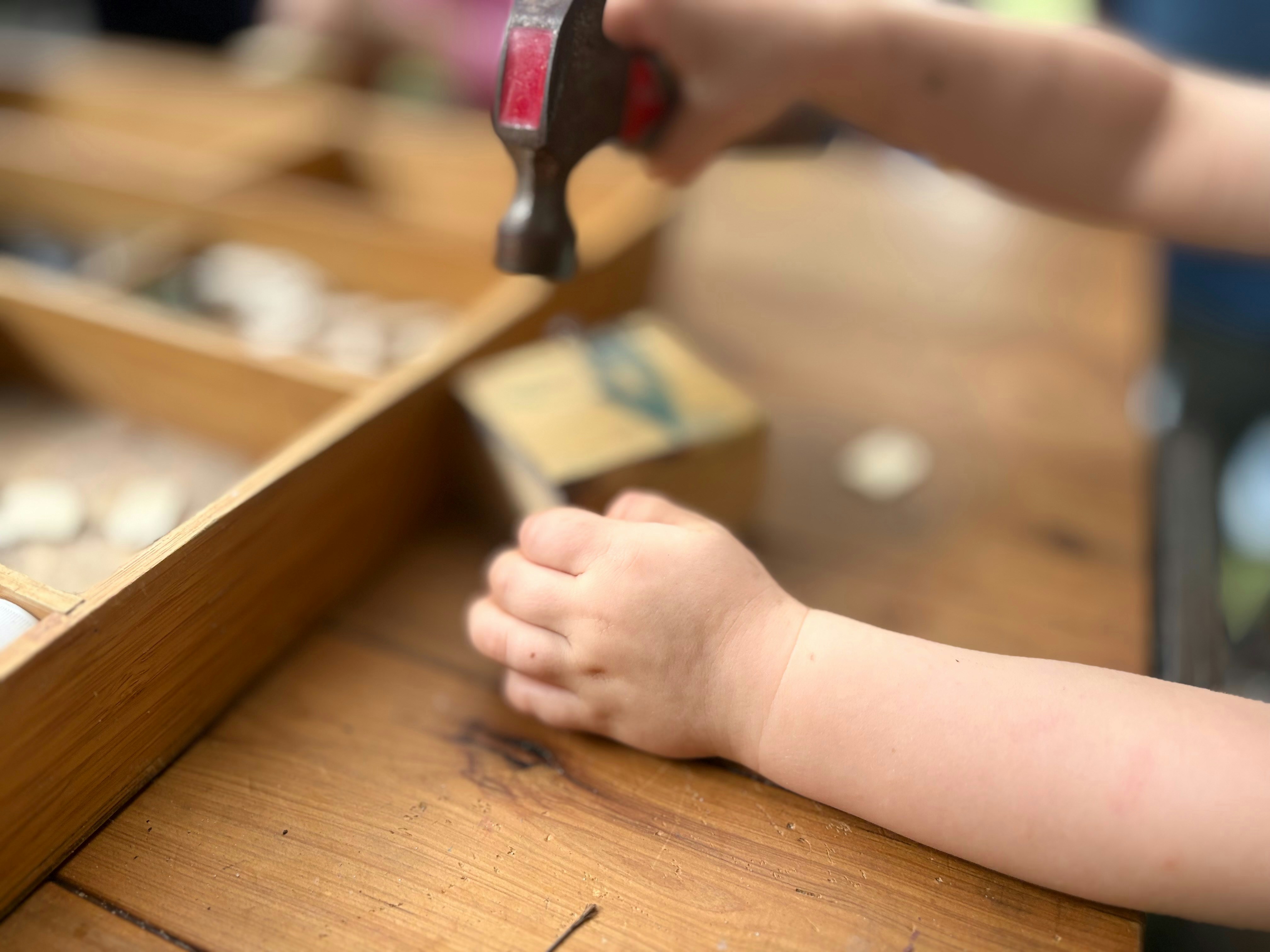 A child is hammering something on a table.
