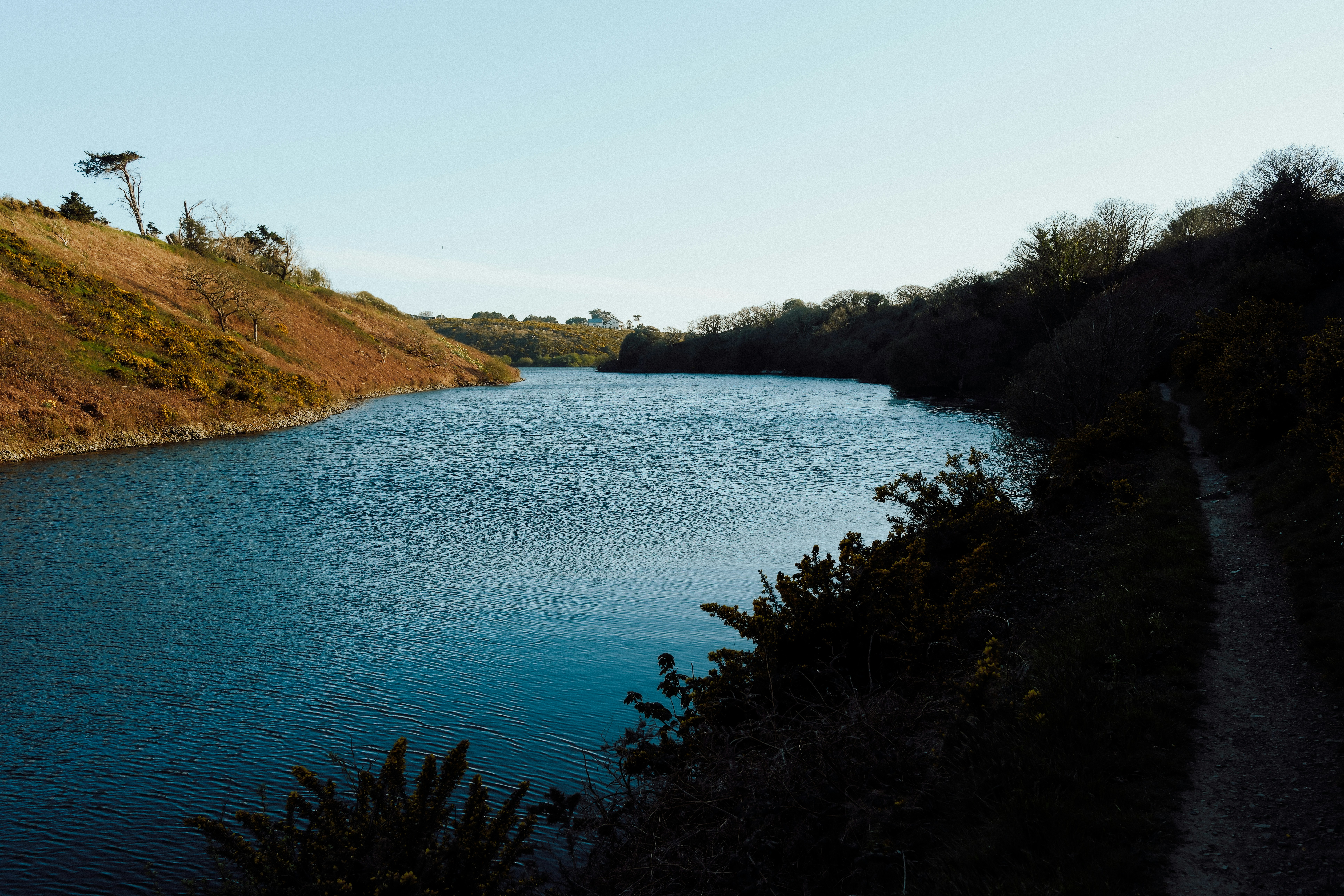 A tranquil lake is nestled between hills.