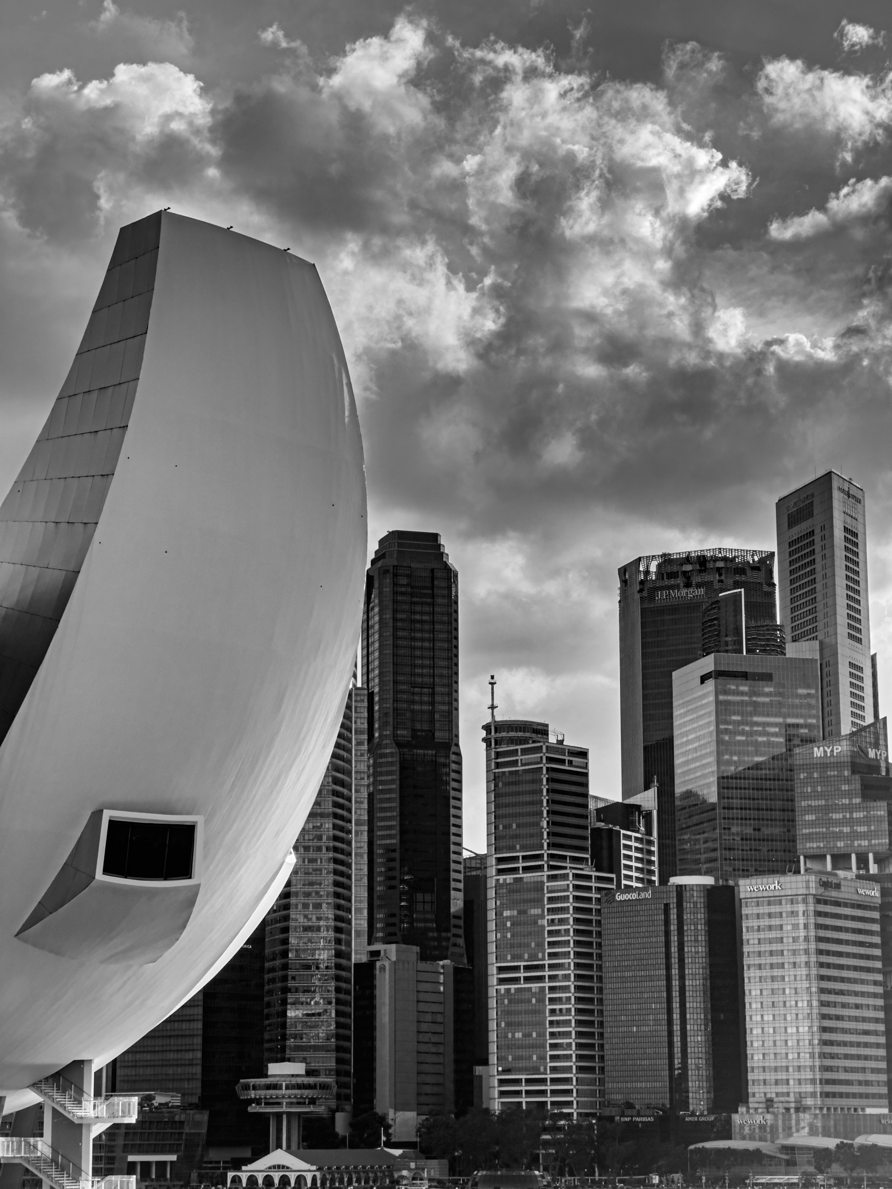 Singapore skyline with a modern building in the foreground.