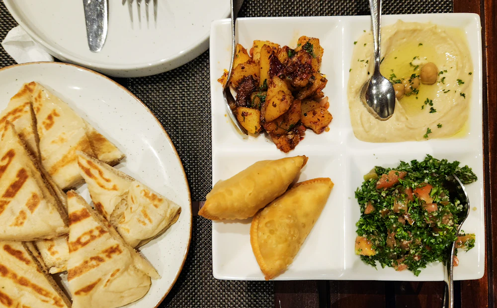 A Lebanese mezze platter with hummus, tabbouleh, warm pita and savoury pastries