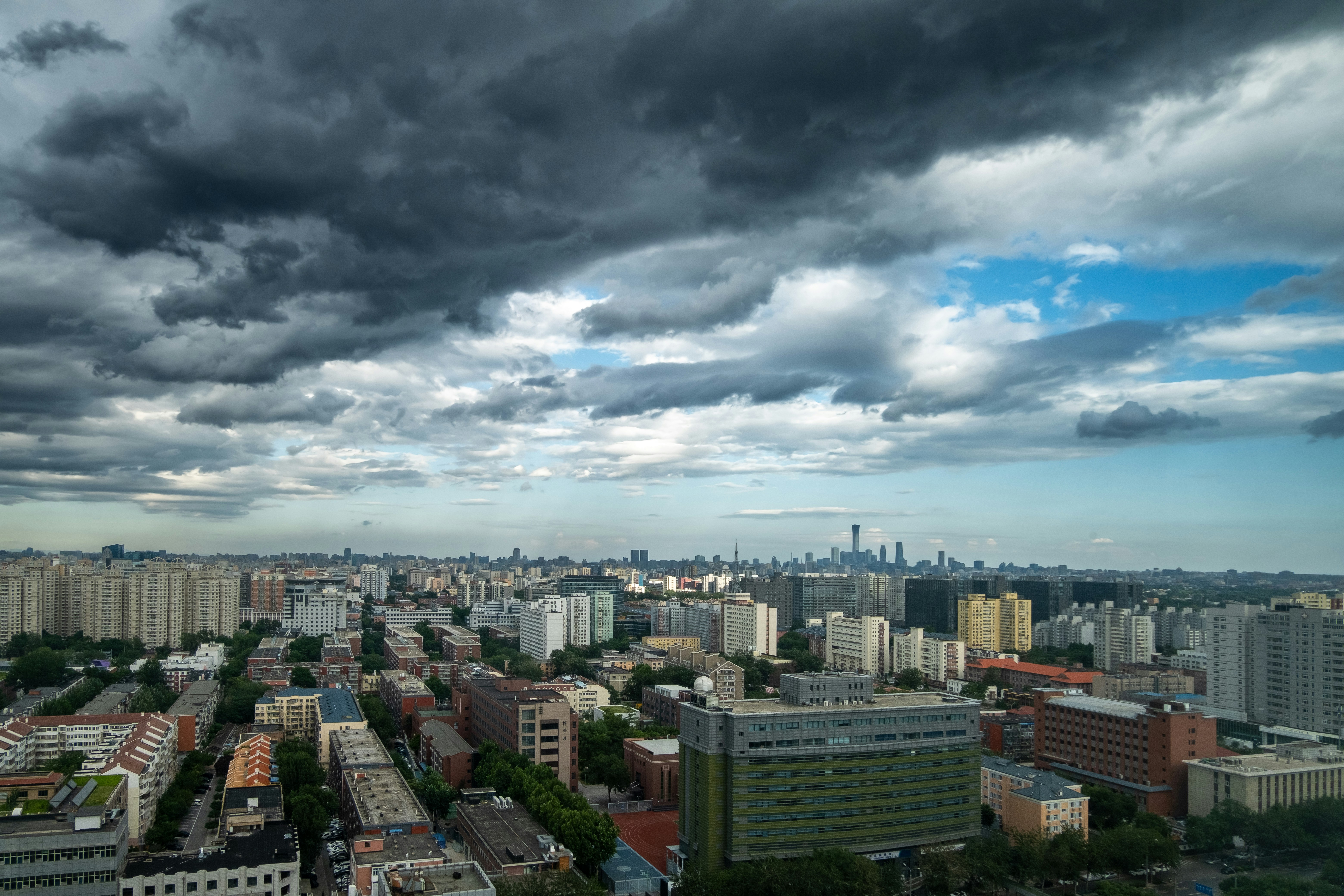 Dark clouds loom over a sprawling city.
