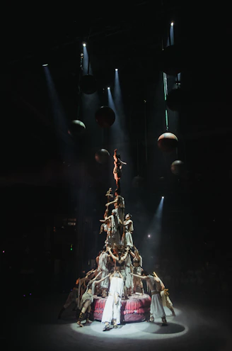 A human tower performance under spotlights.