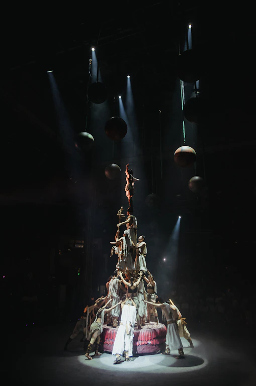 A human tower performance under spotlights.