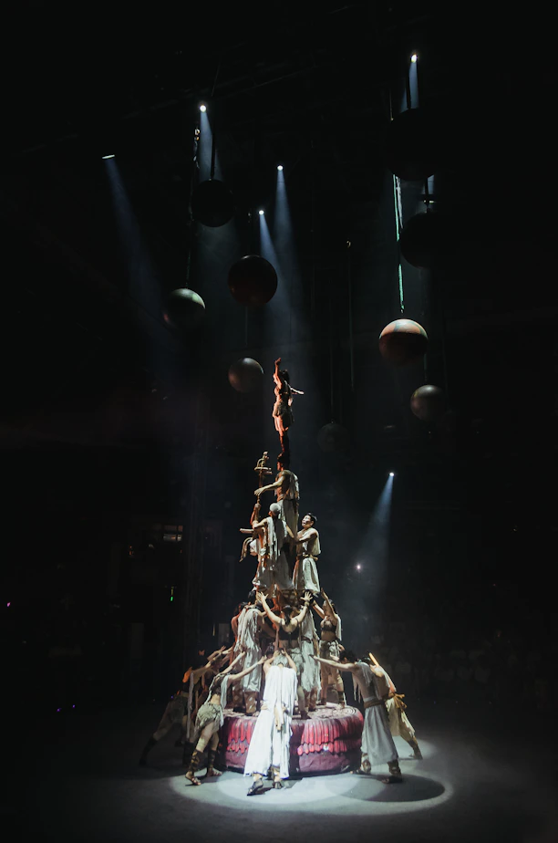 A human tower performance under spotlights.