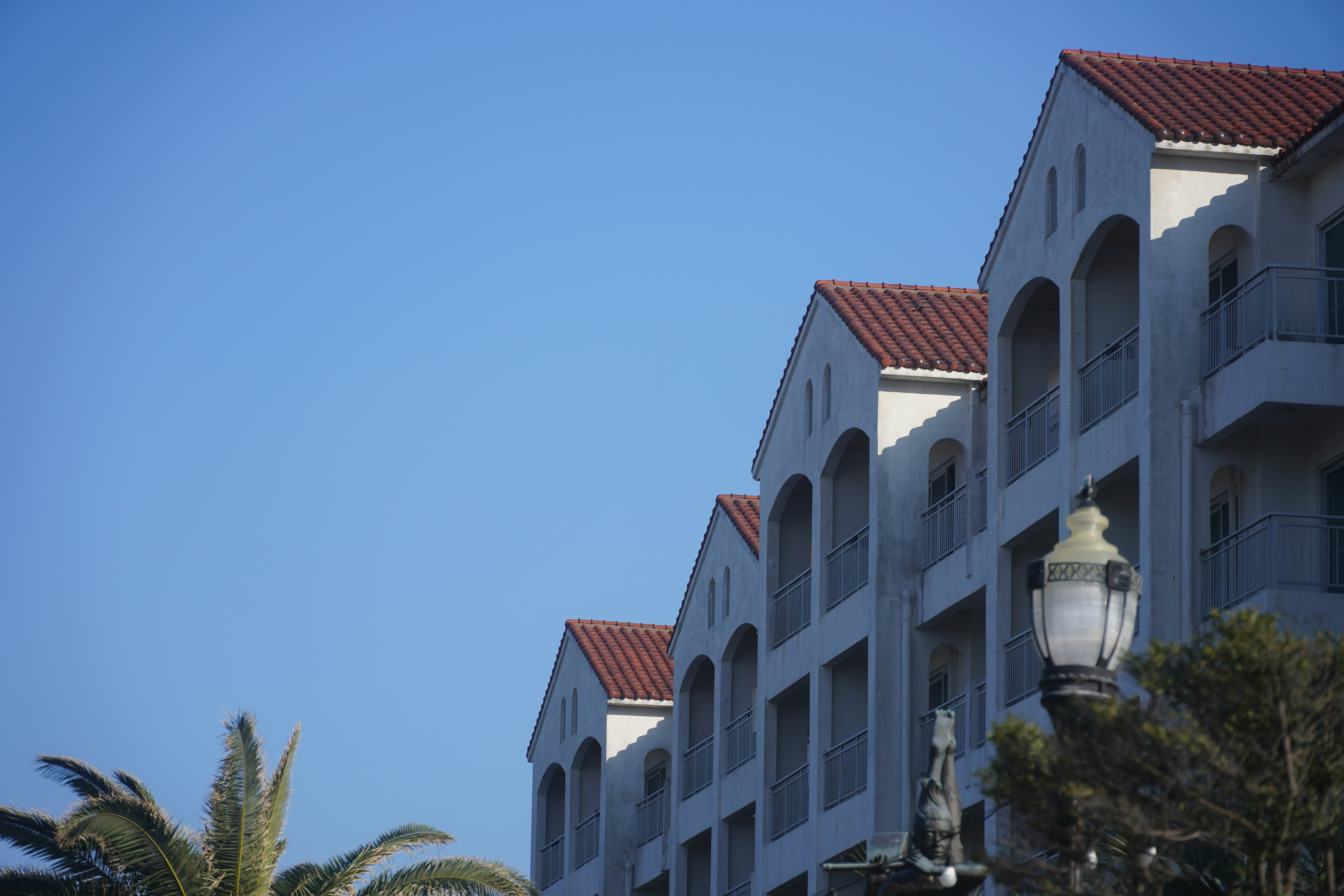 Buildings with arched windows against a blue sky.