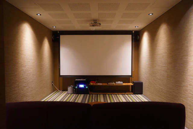 Custom home theater with large screen and wood cabinetry