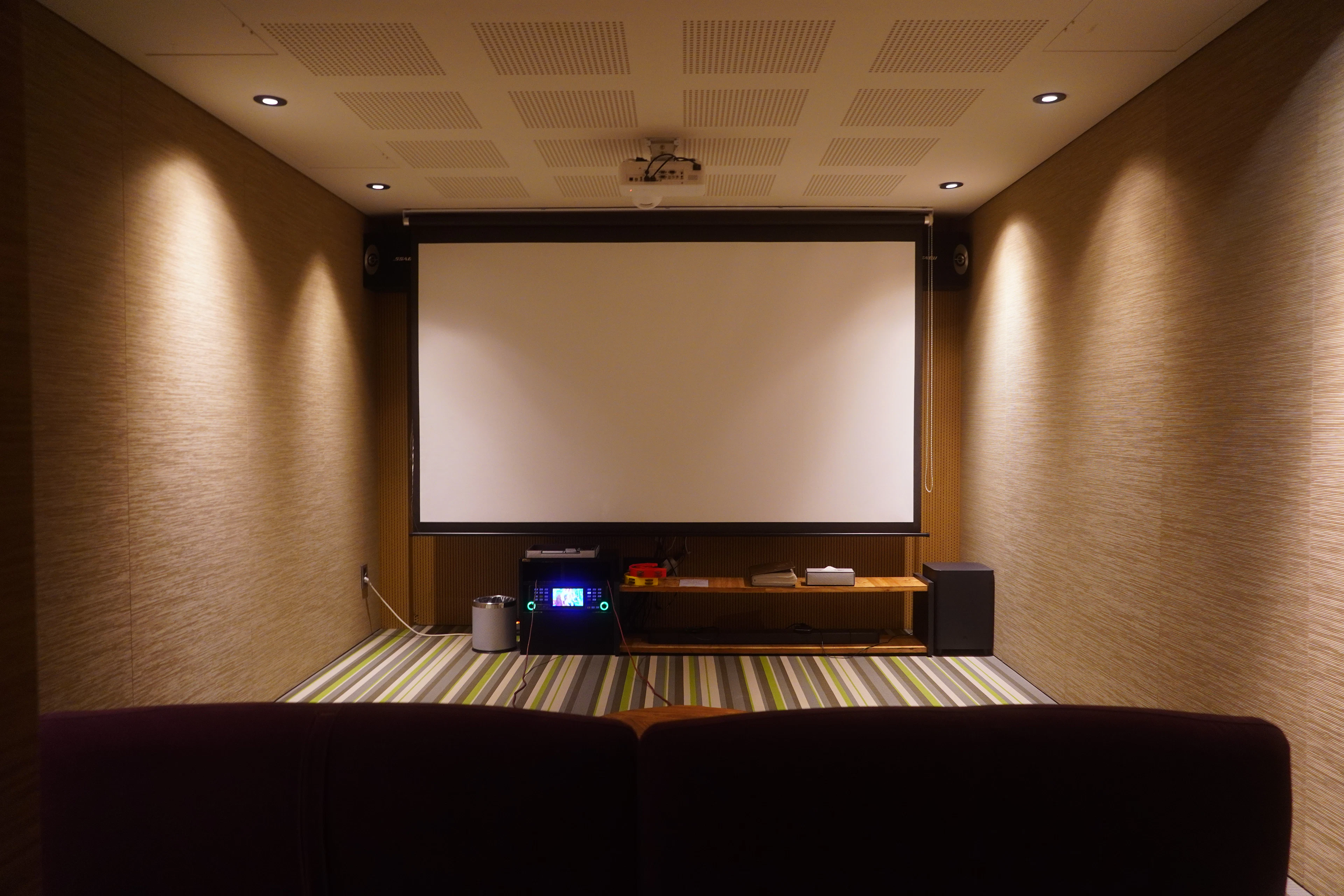 Home theater room with a large screen and comfortable seating