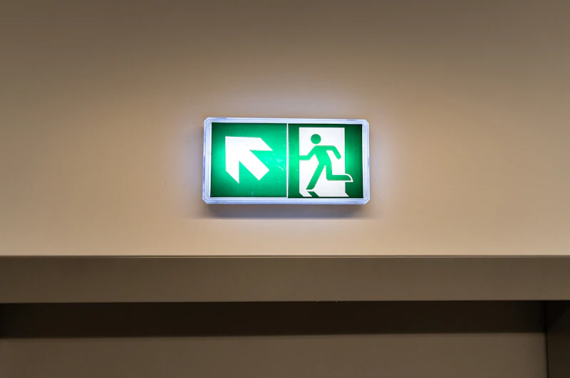 Green fire exit sign on door
