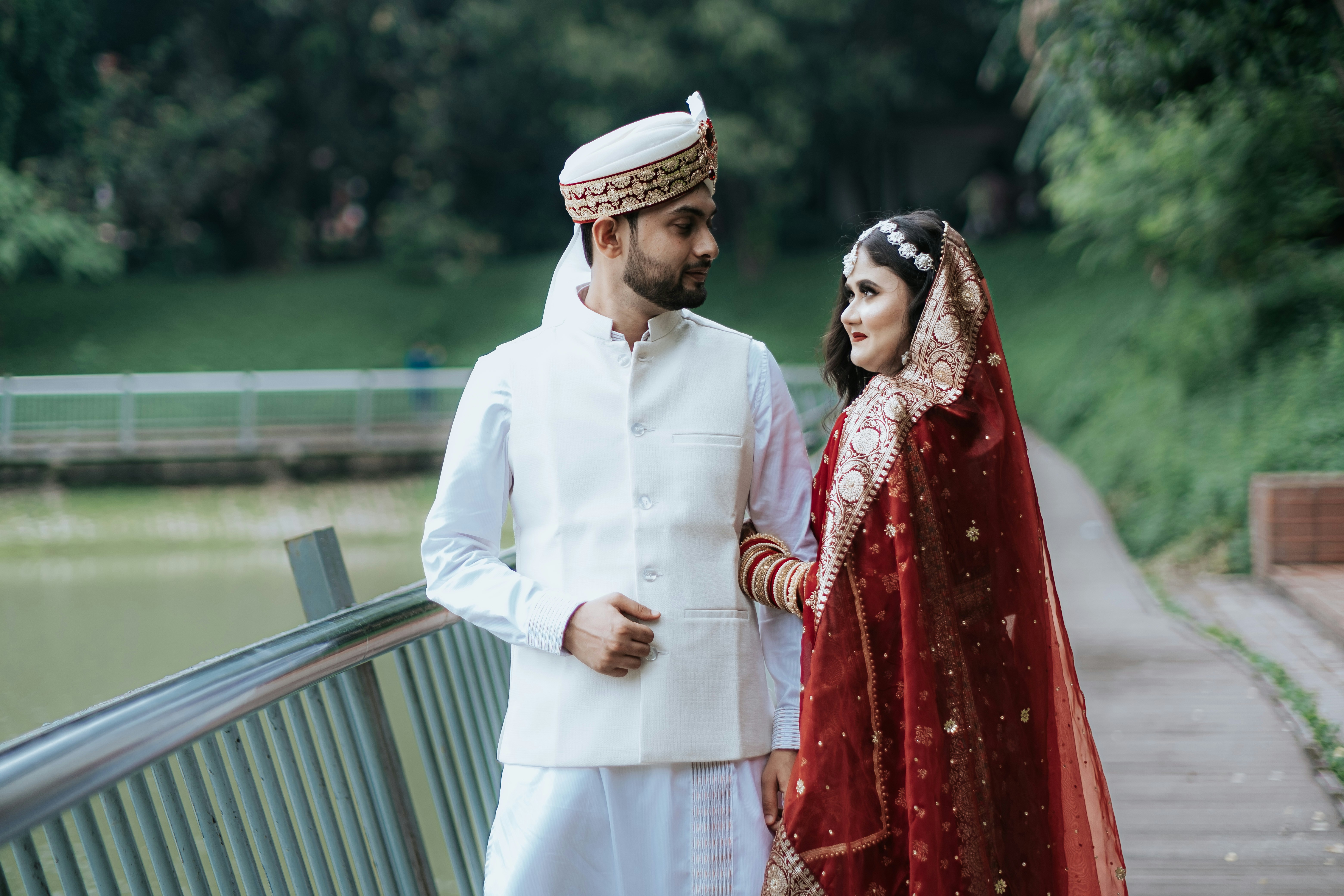 A newlywed couple looks at each other lovingly.