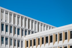 Modern white building against a clear blue sky.