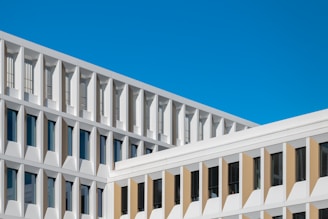 Modern white building against a clear blue sky.