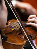 A person plays a violin during a performance.