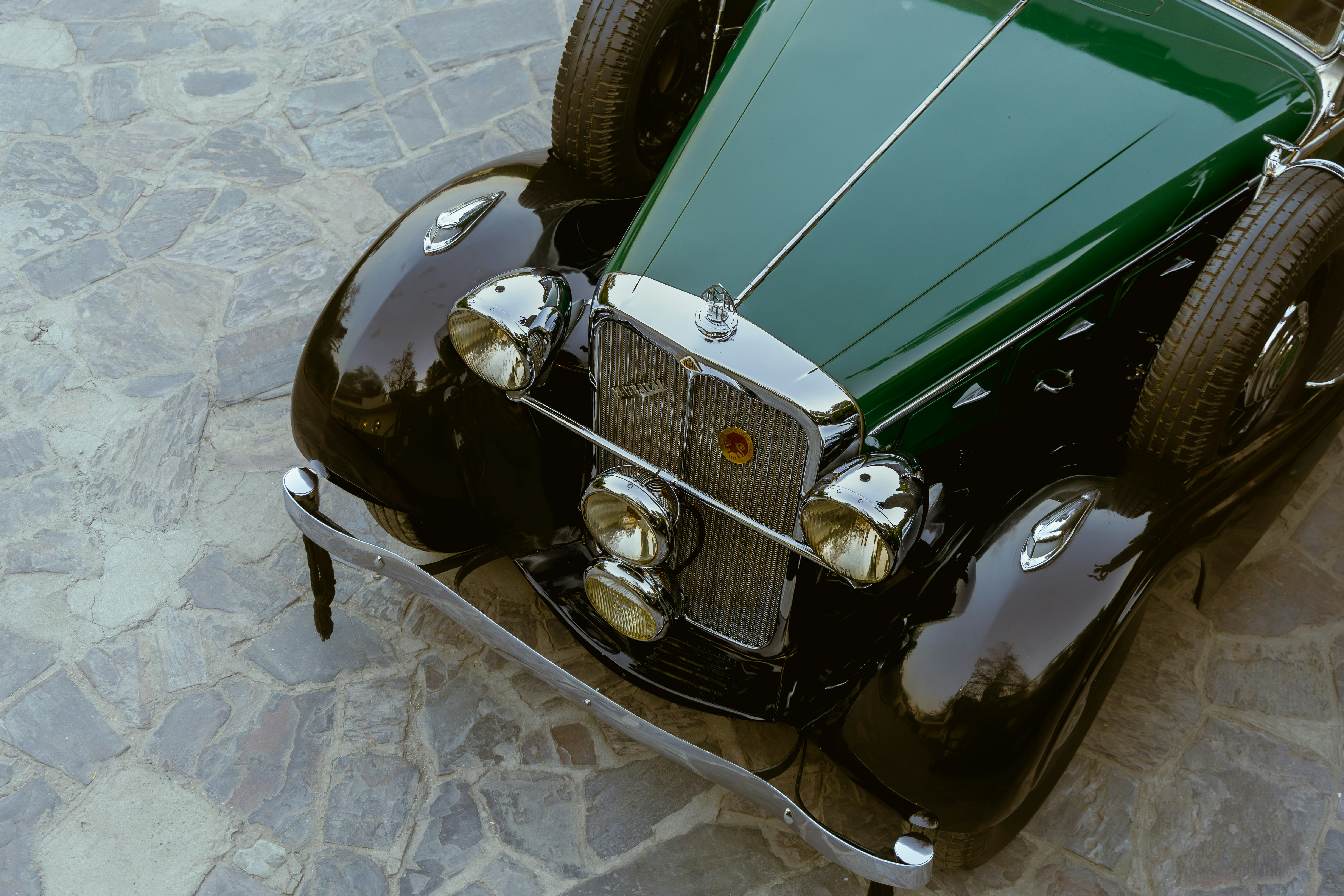 Classic green and black car with chrome accents.
