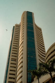 A tall building towers into the blue sky.
