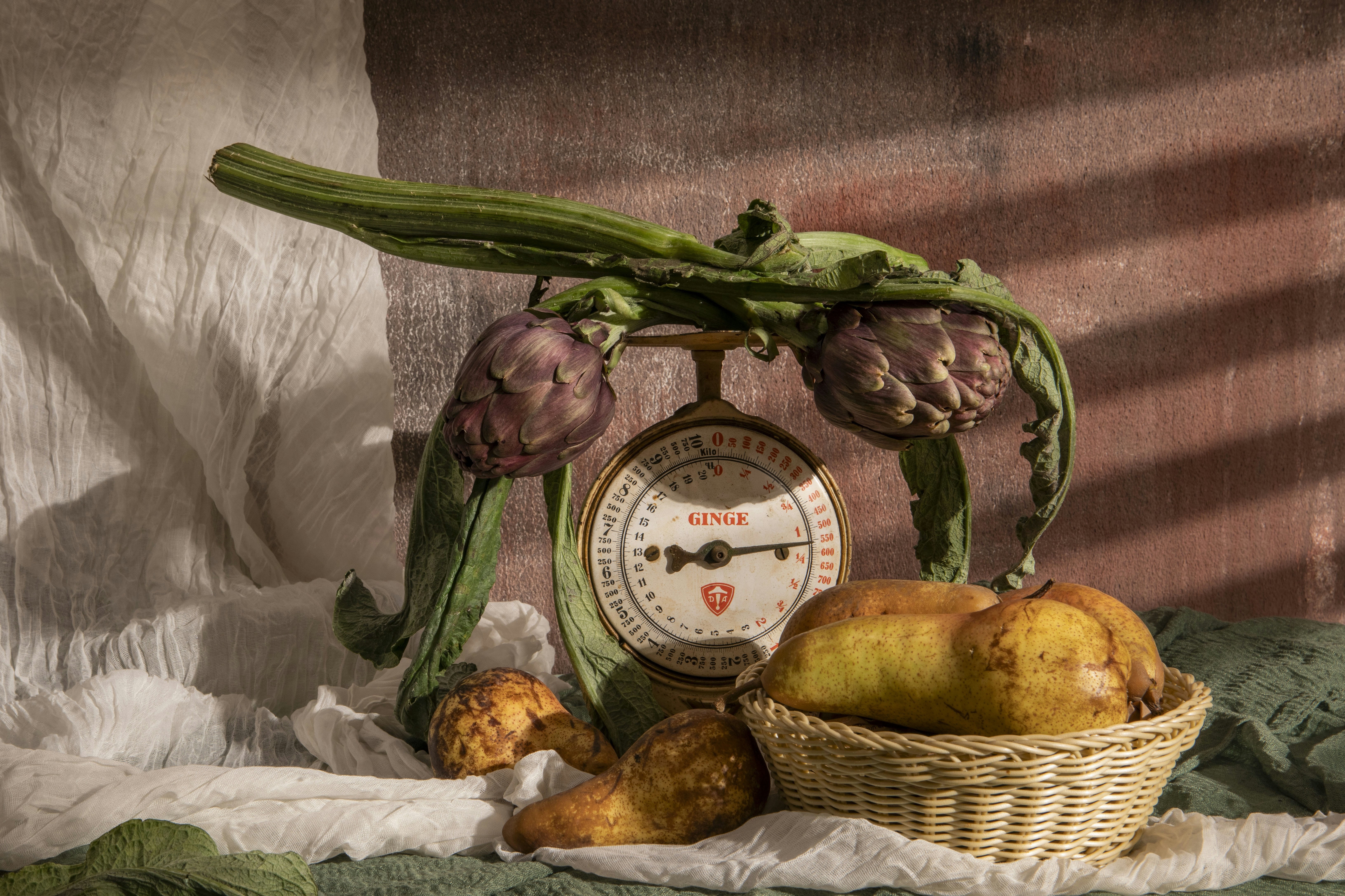 Vegetables are displayed with an antique scale.