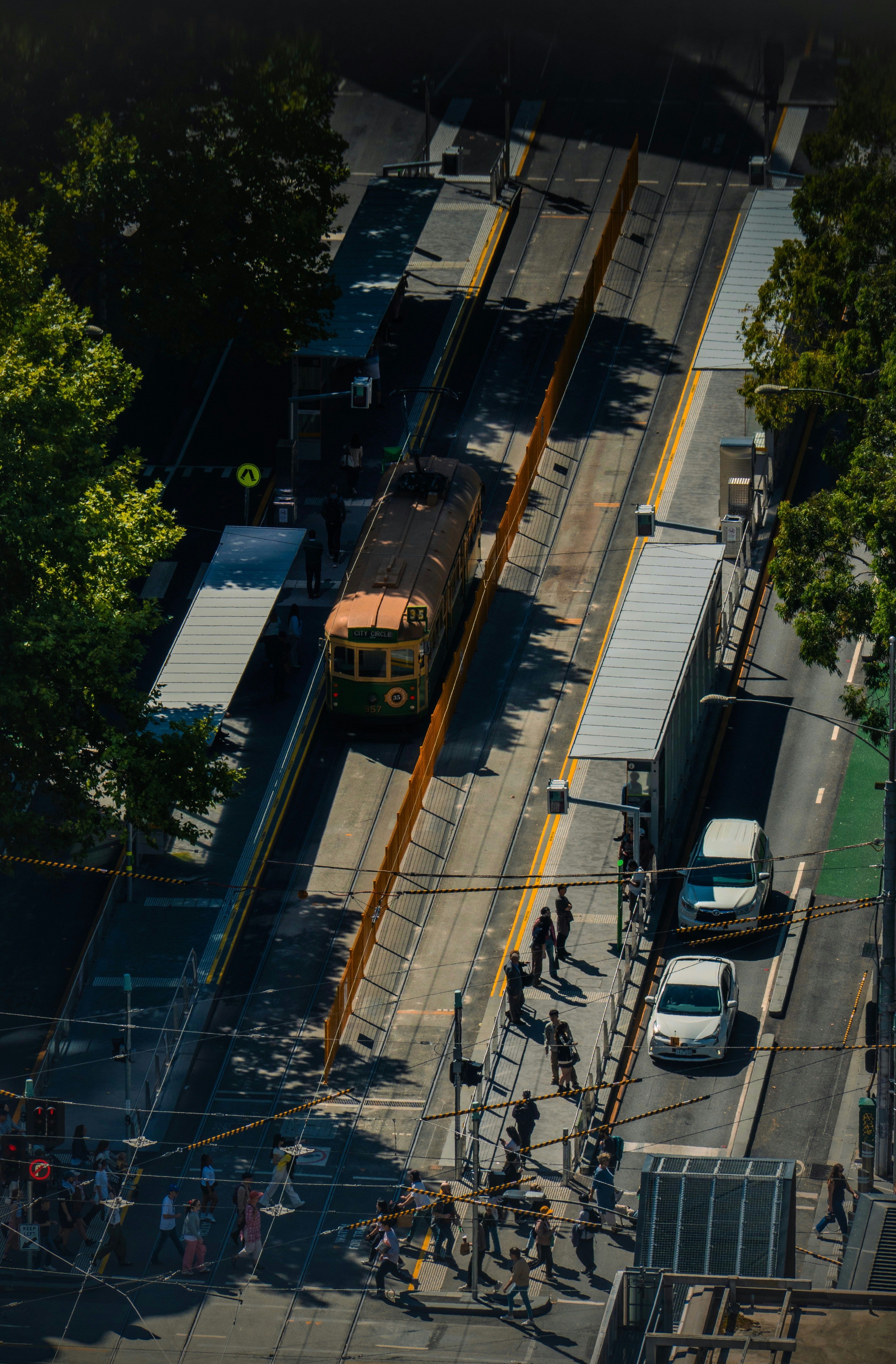 A vintage tram moves along city tracks.