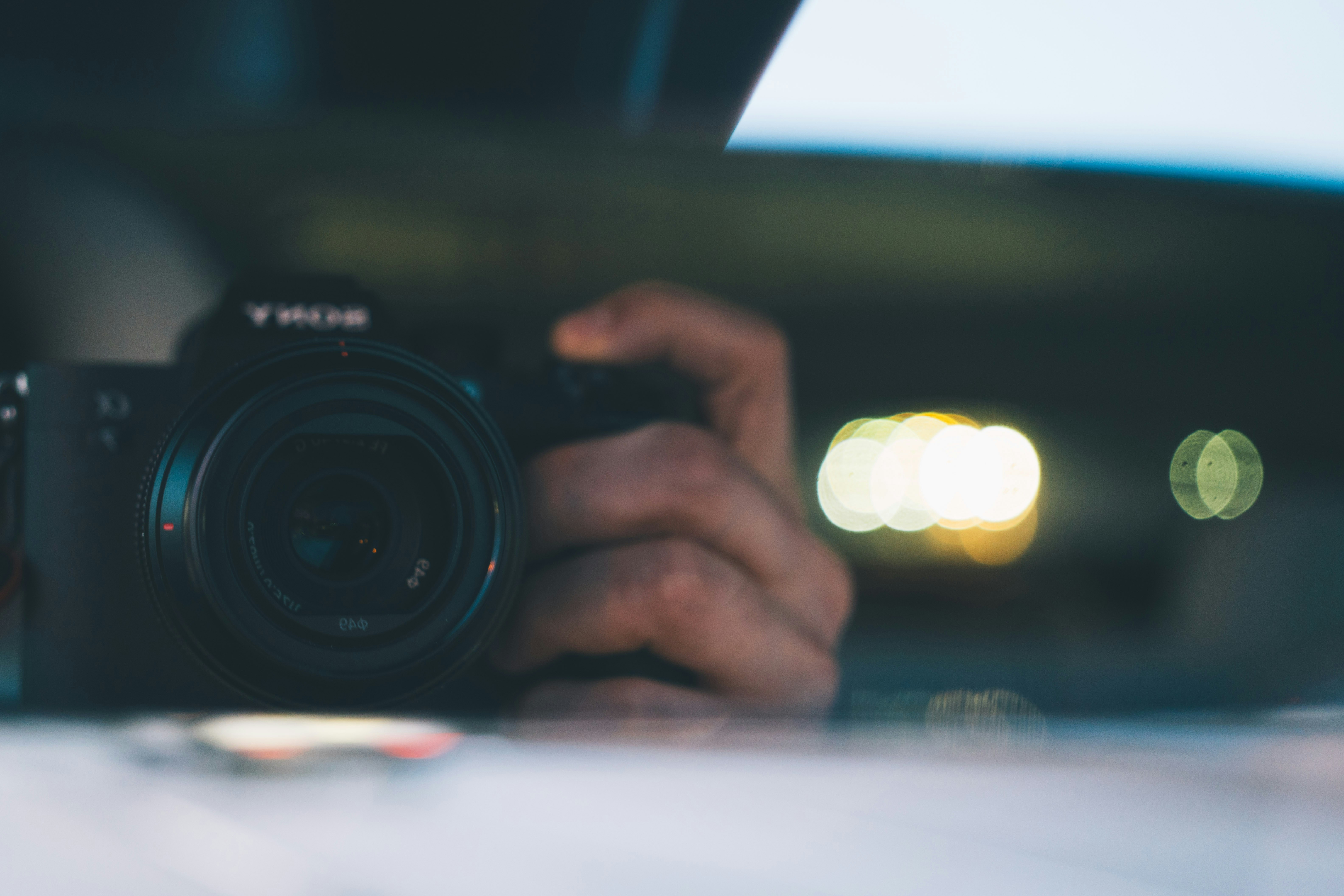 A camera reflects in a mirror.