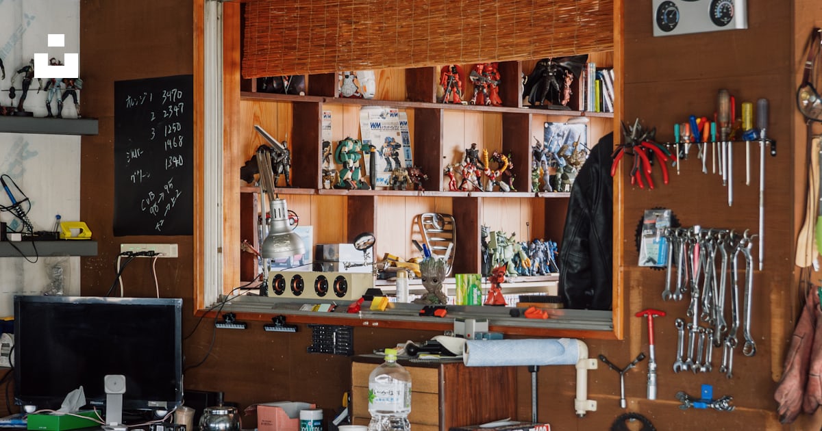 A cluttered garage displays tools, toys, and equipment. photo – Free ...