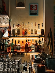 A well-stocked bar displays assorted liquor bottles.