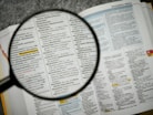 Magnifying glass over a keywords document for SEO