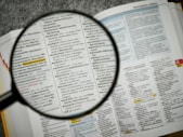 Magnifying glass over a keywords document for SEO