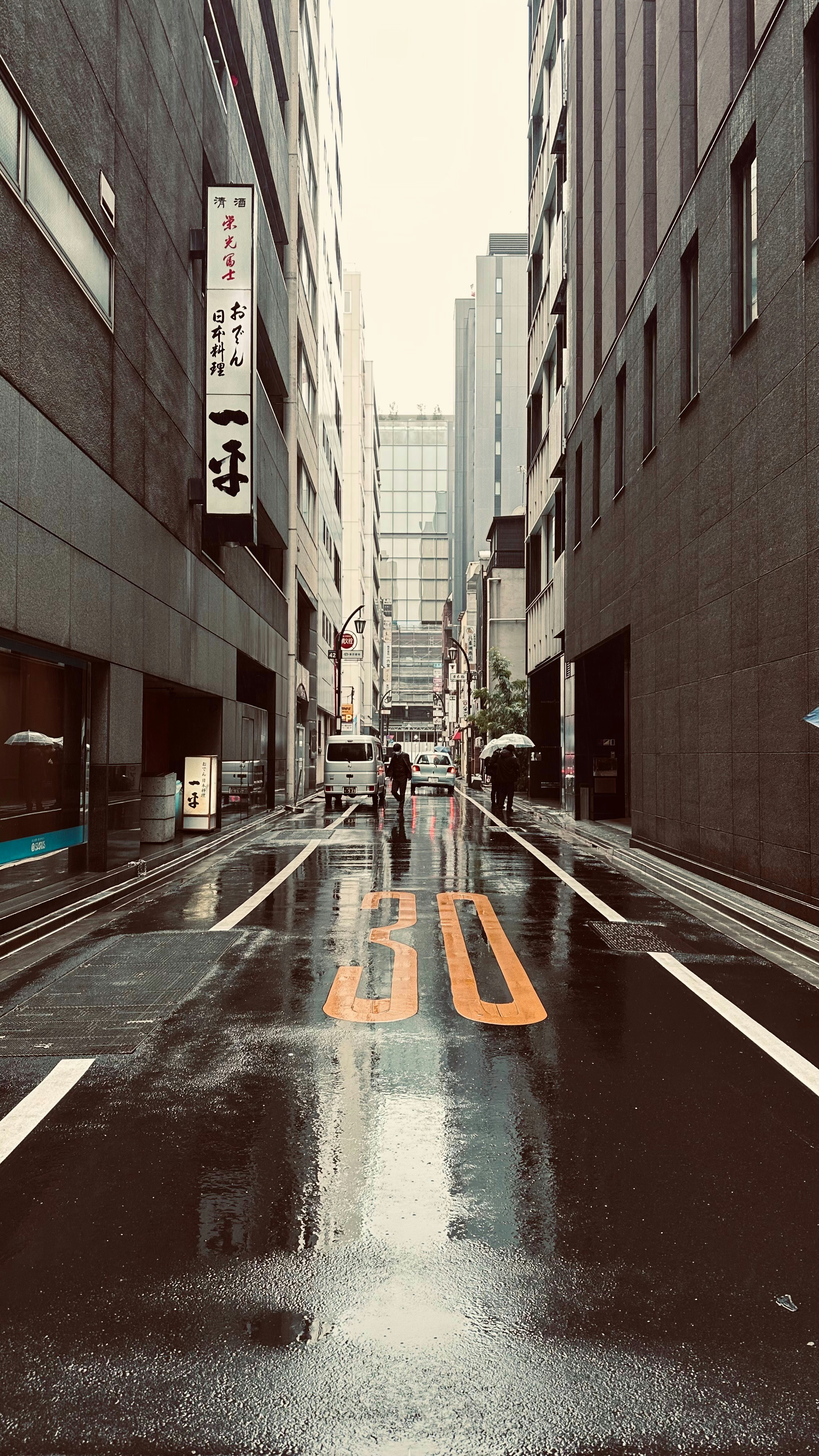 Rainy alley in a city with buildings.