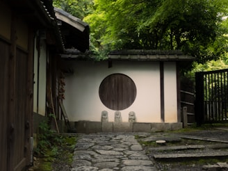 A japanese temple with a round door is shown.