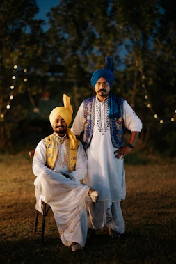 Two men in traditional punjabi attire pose.