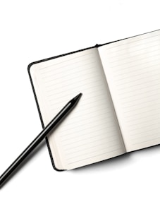 Notebook with a pencil on top.