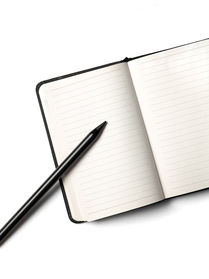 Notebook with a pencil on top.