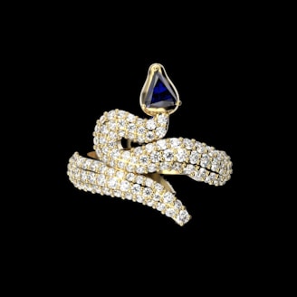 Diamond and sapphire snake ring, elegant design.