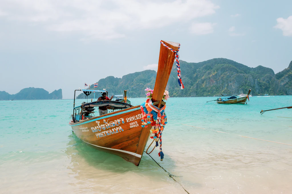 Wooden longtail boat resting on turquoise water