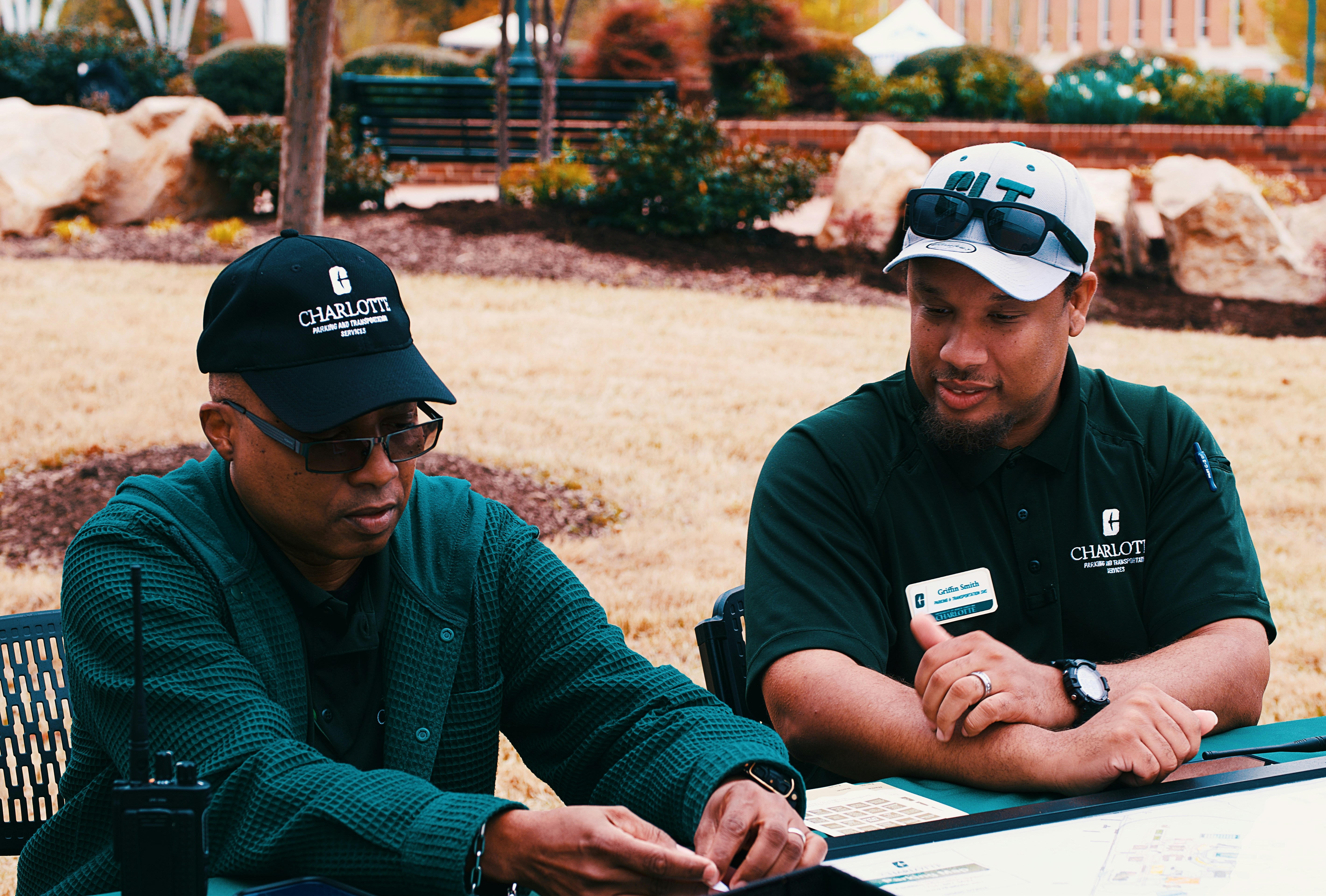 landscape consultant reviewing blueprints on-site with a homeowner