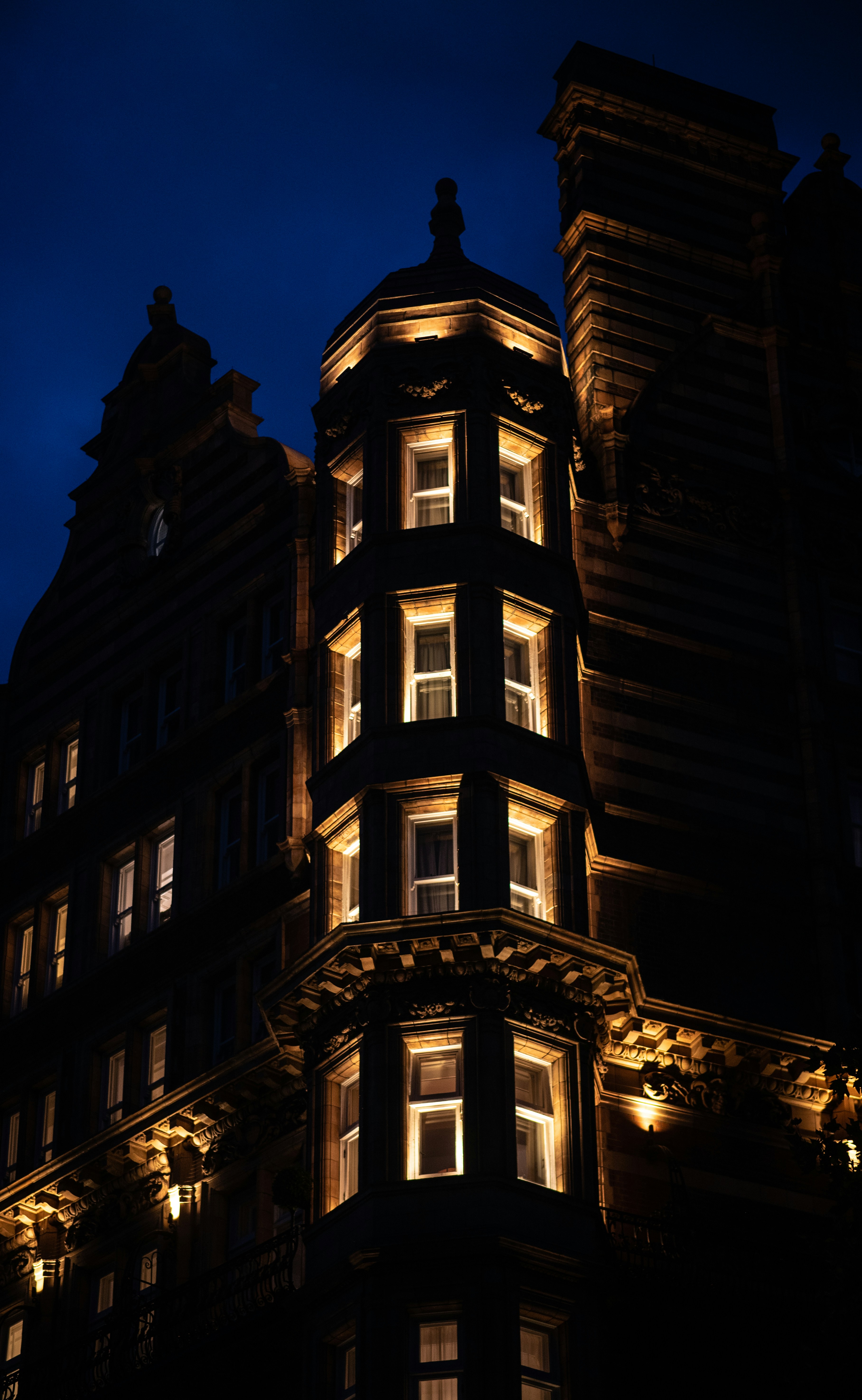 A lit building's tower is seen at night.