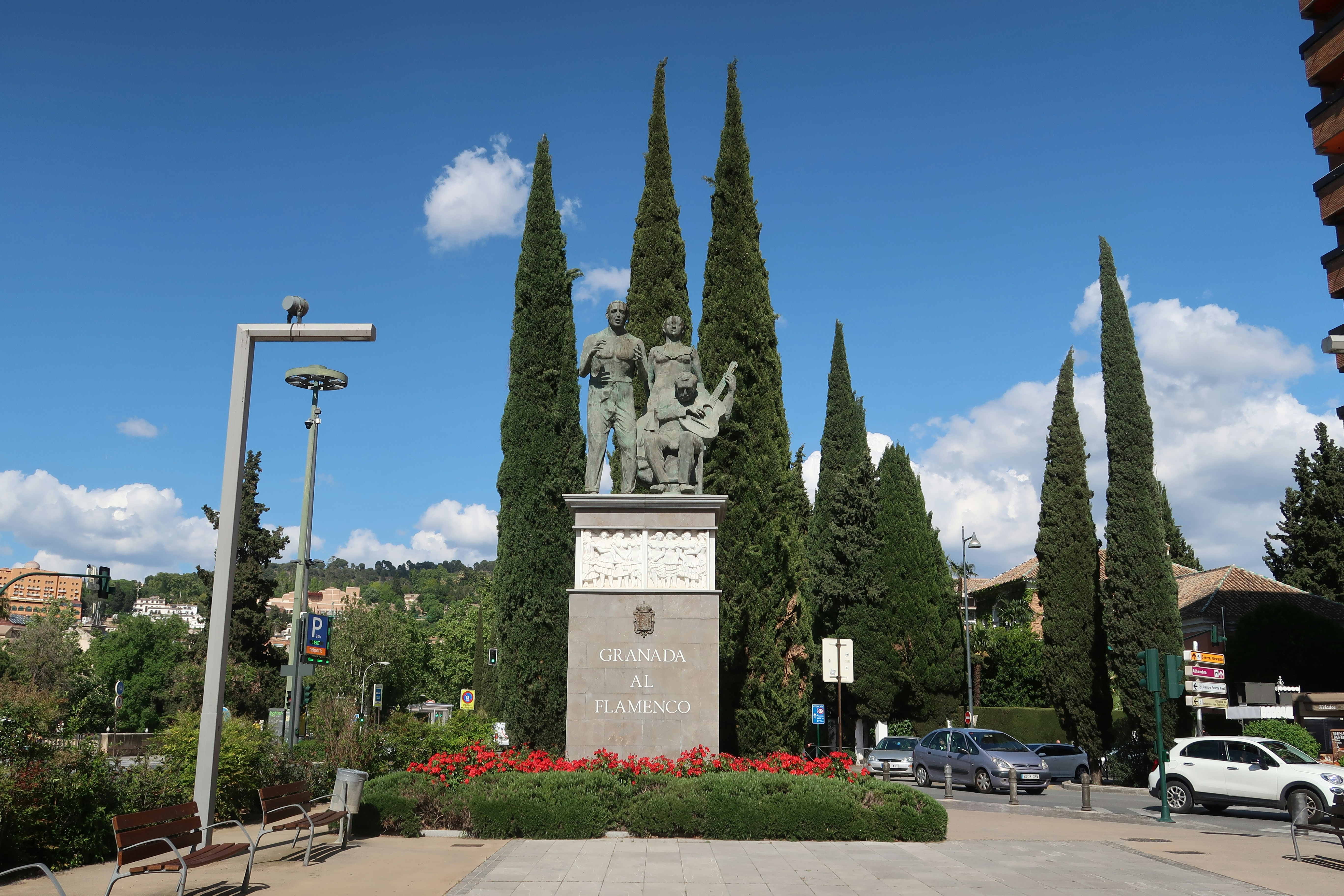Statue with tall trees in a beautiful park.
