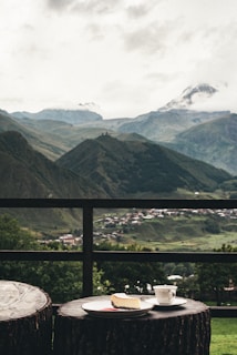 Coffee, cake, and mountain views on a cloudy day.