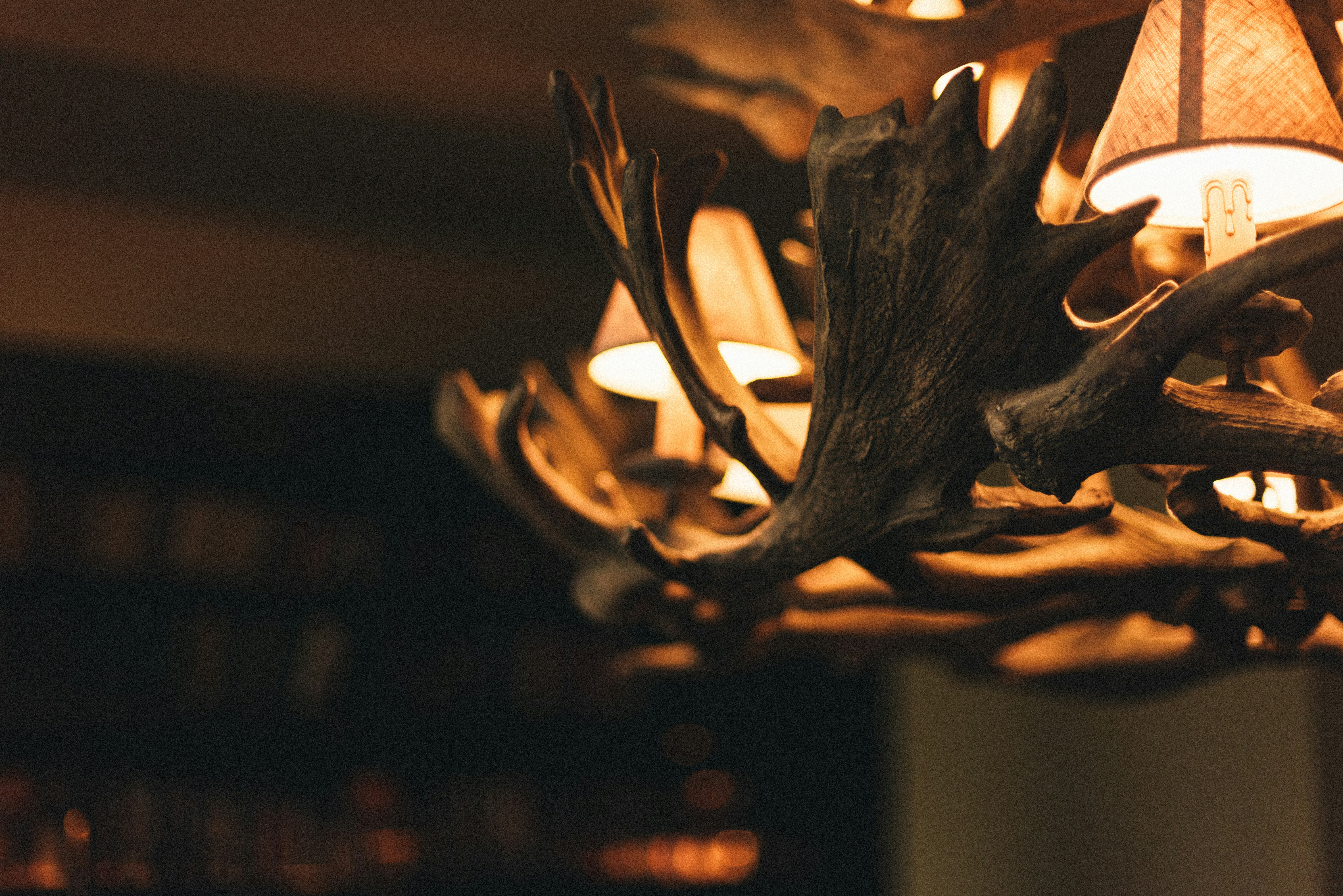A rustic chandelier with antler decorations.